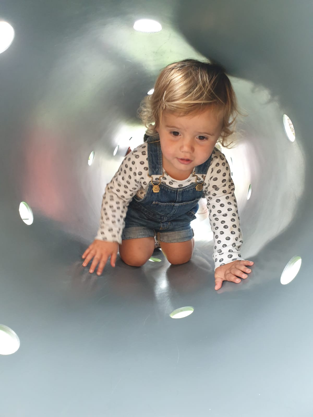 Child playing in tunnel